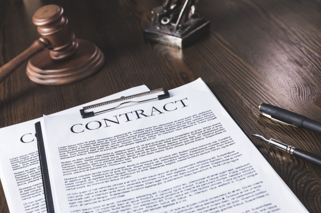 Contract on wooden table with gavel